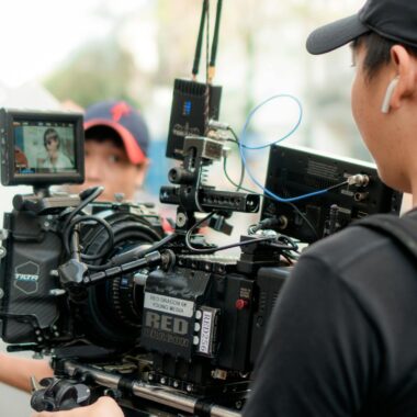 Cinematographer working with advanced film equipment on an outdoor set.